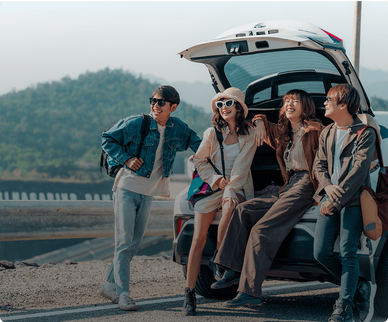 A group of people standing next to an open trunk.