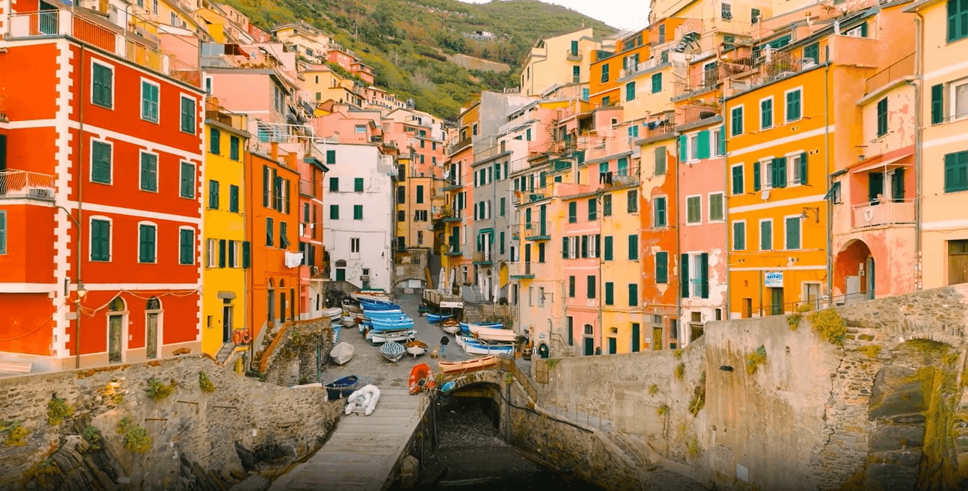 Colorful seaside village with boats and buildings.